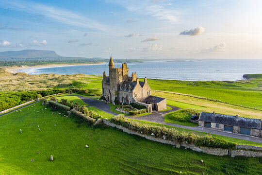 Classiebawn Castle on a backdrop of picturesque landscape of Mullaghmore Head. Spectacular sunset view with waves rolling ashore. Signature point of Wild Atlantic Way, Co. Sligo, Ireland