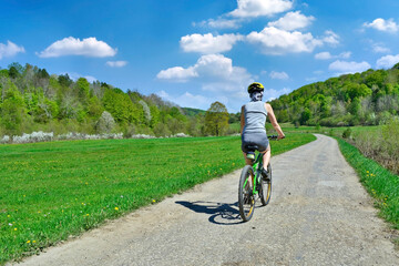 Woman riding a bicycle on a sunny spring day