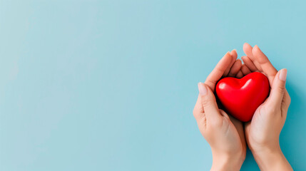 Obraz premium Woman's hands holding red heart on grey background. Valentine's day, health care, world heart day, world health day.