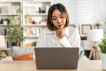 Young smiling asian woman happy relax use laptop conference work,learning, education, shopping, study online, webinar, online marketing, business, blog, digital internet advertising at home
