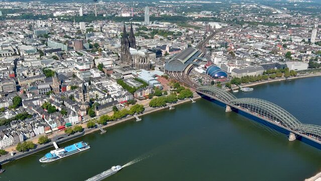 Aerial view Cologne Old Town in Germany. Above shot of over the river Rhine ft Museum Ludwig, Cathedral, Hohenzollern Bridge, Central Station, Musical Dome, on a sunny day in North Rhine-Westphalia 4K