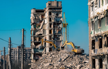 construction equipment destroys houses damaged during the war in Ukraine