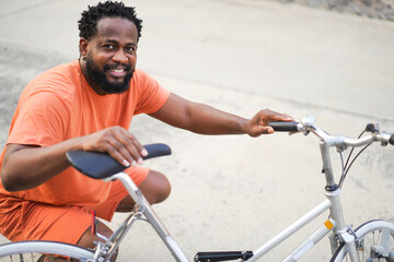 Portrait of successful handsome attractive confident young black african man commuting riding bicycle on the street way go to work.business travel transport bike concept
