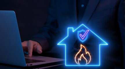 Businessman working with computer laptop and showing animation of neon line house with shield guard with fire icon. Protection and home and fire insurance concept.