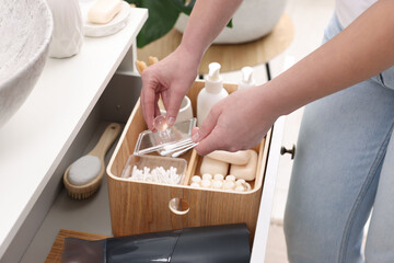 Bath accessories. Woman with cotton buds indoors, closeup