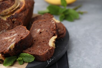 Delicious banana bread on grey table, closeup. Space for text