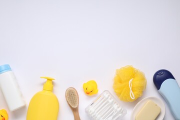 Different baby bath accessories and cosmetic products on white background, flat lay. Space for text