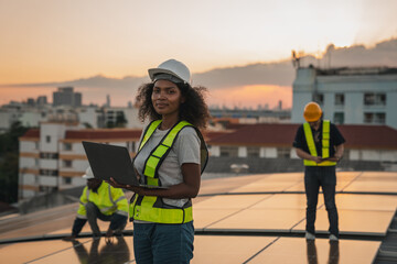 Portrait of Service engineer checking solar cell on the roof for maintenance if there is a damaged...