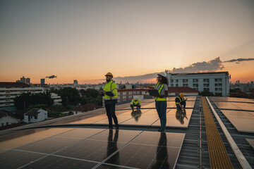 Obraz premium Service engineer checking solar cell on the roof for maintenance with drone technology. Engineer worker install solar panel. Clean energy concept.