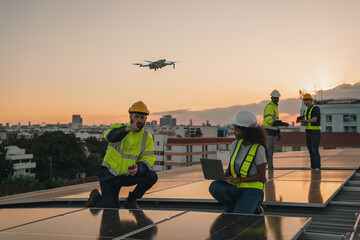 Service engineer checking solar cell on the roof for maintenance with drone technology. Engineer...