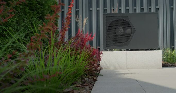 The heat pump for heating the pool is mounted on site. Ornamental plants nearby. Energy Saving Technologies. Slider shot