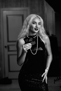 Portrait of a young beautiful blonde girl. Black and white photo.