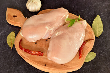 Two chicken breasts are ready to cook.