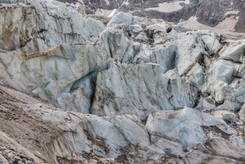 Melting glacier at the foot of a high mountain.