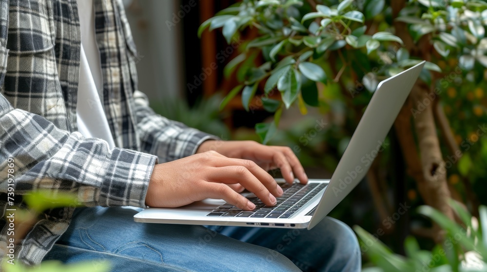 Poster farmer using laptop in rural setting with blurred background and space for text placement