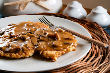 Sauerkraut pancakes /fuczka/ with mushroom sauce .