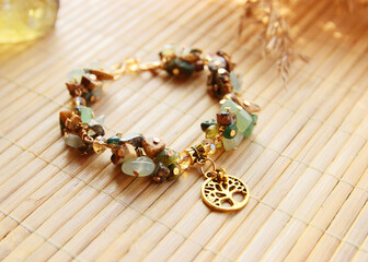 Delicate vintage bracelet made of a mix of natural stones jasper, jade with a golden tree of life...