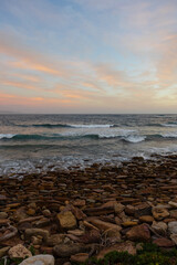 Fototapeta na wymiar Beautiful sunrise view on a rocky beach.