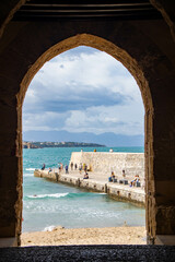 view through an arch of the coastline at Cefalu