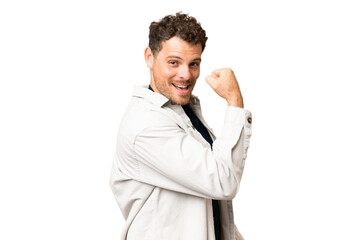 Brazilian man over isolated chroma key background doing strong gesture