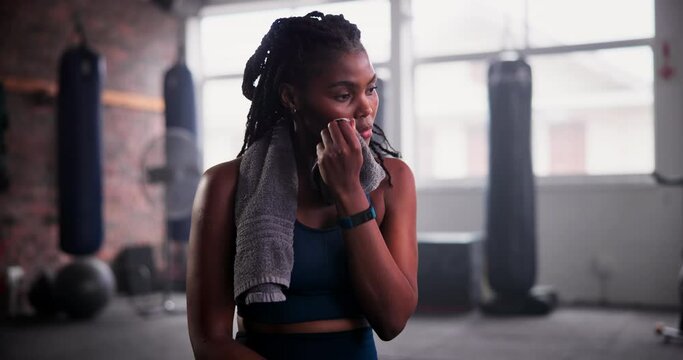 Gym, towel and tired black woman with fitness break, breathing or recovery from intense performance. Sport, burnout or Aftican female athlete sweating from physical challenge, workout or training