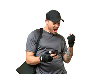 Young sport man with sport bag over isolated chroma key background with phone in victory position