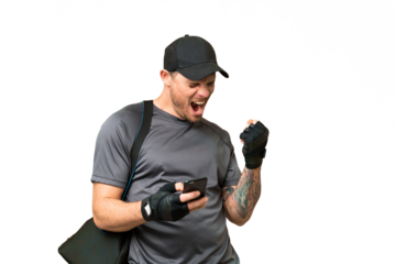 Young sport man with sport bag over isolated chroma key background with phone in victory position