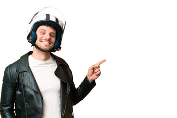 Brazilian man with a motorcycle helmet over isolated chroma key background pointing finger to the...