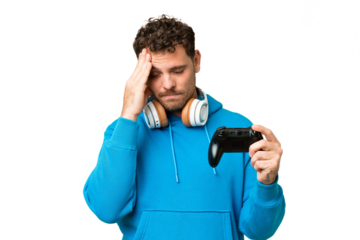Brazilian man playing with a video game controller over isolated chroma key background with headache
