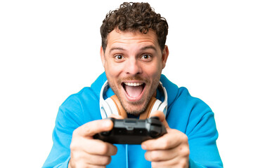 Brazilian man playing with a video game controller over isolated chroma key background © luismolinero
