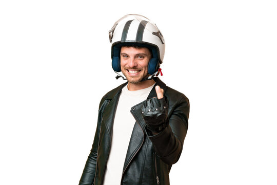 Brazilian man with a motorcycle helmet over isolated chroma key background making money gesture
