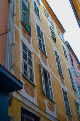 Fototapeta na wymiar Nice, France, 02/13/2024: The architecture of the old town in Nice boasts a blend of Italian style with French motifs, characterized by colorful houses and narrow streets.
