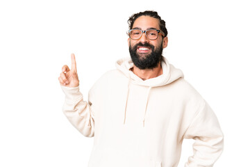 Young man with beard over isolated chroma key background showing and lifting a finger in sign of the best