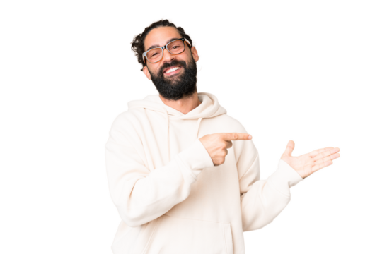 Young man with beard over isolated chroma key background holding copyspace imaginary on the palm to insert an ad