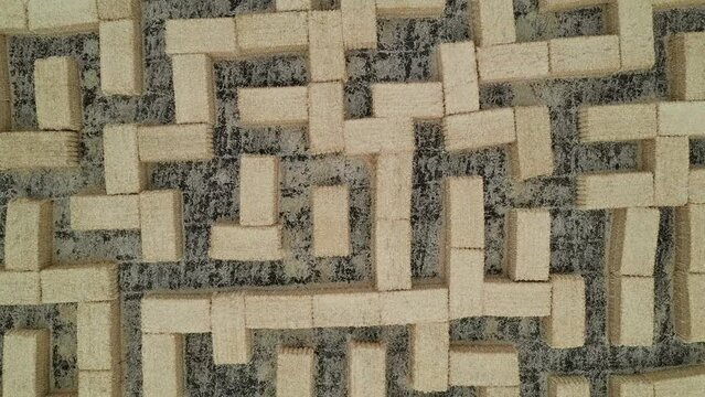 Huge hay labyrinth, straw maze, hay maze. Aerial bird's eye drone view on a field.