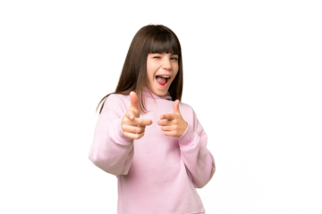 Little girl over isolated green chroma key background pointing to the front and smiling