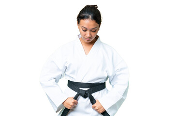 Young Uruguayan woman over isolated chroma key background doing karate