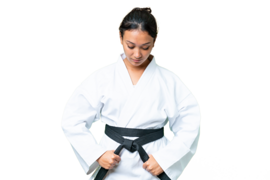 Young Uruguayan woman over isolated chroma key background doing karate