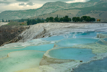 Travertines of Pamukkale in winter. Turkish famous white thermal bath with healthy clear water