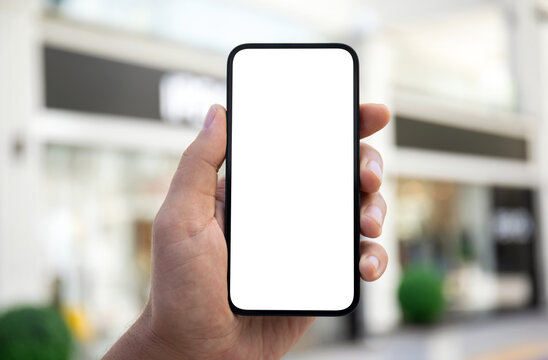 Man hand hold phone with isolated screen background shopping center