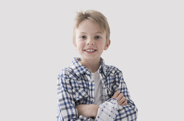 Cute boy posing with arms crossed