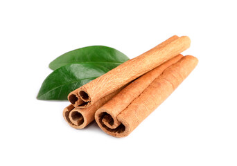 Cinnamon sticks and green leaves isolated on white
