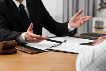 Senior man having meeting with lawyer in office, closeup