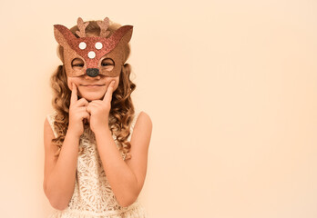 Unique child. Happy child in deer costume. Little cute girl in a carnival masquerade deer mask made of foamiran. The child is preparing to celebrate festival.