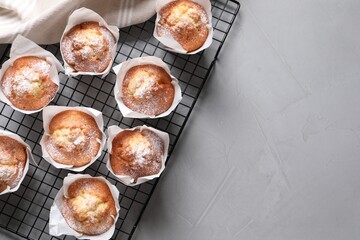 Delicious muffins on light table, top view. Space for text