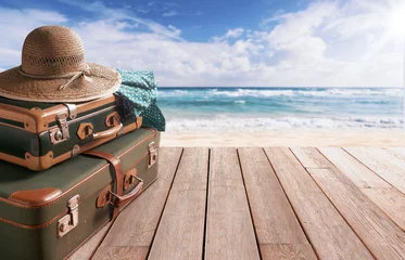 Fotobehang Afdaling naar het strand Vintage style suitcases at the beach