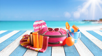 Travel bag and accessories on the beach