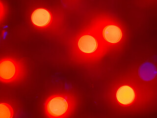 abstract background with bokeh defocused lights on red background