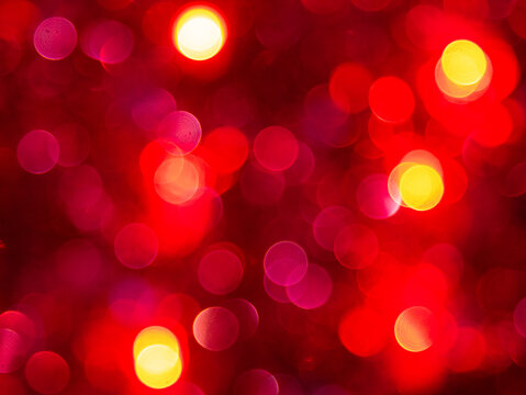 abstract background with bokeh defocused lights on red background