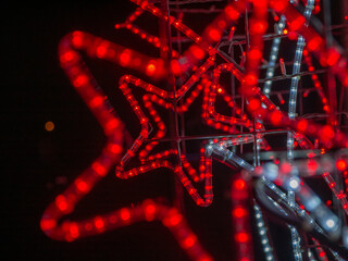 Abstract background of red lights star on the Christmas tree. Shallow depth of field.